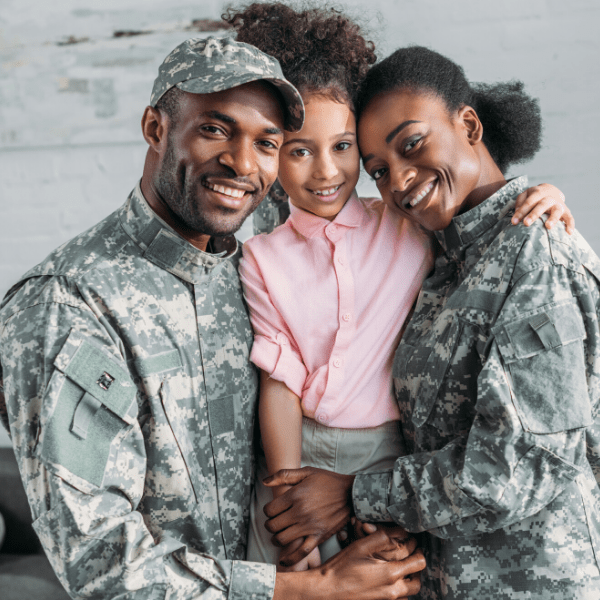 Military parents embracing their daughter at Behl Orthodontics