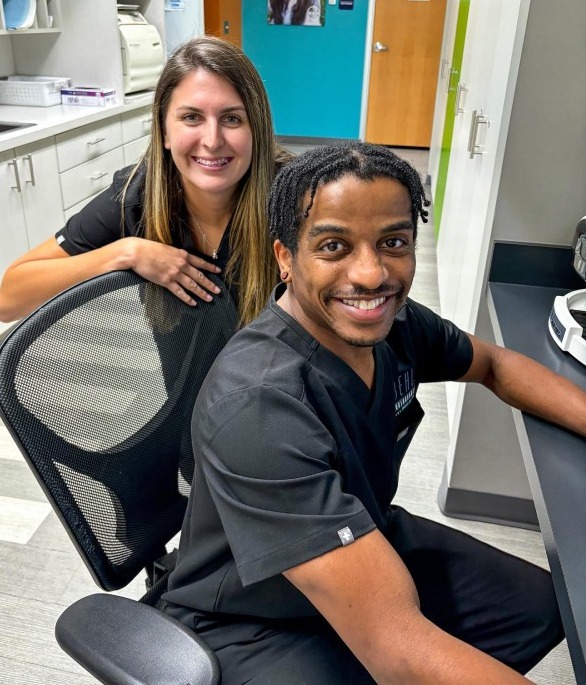 Two Behl Orthodontics assistants working together at the computer