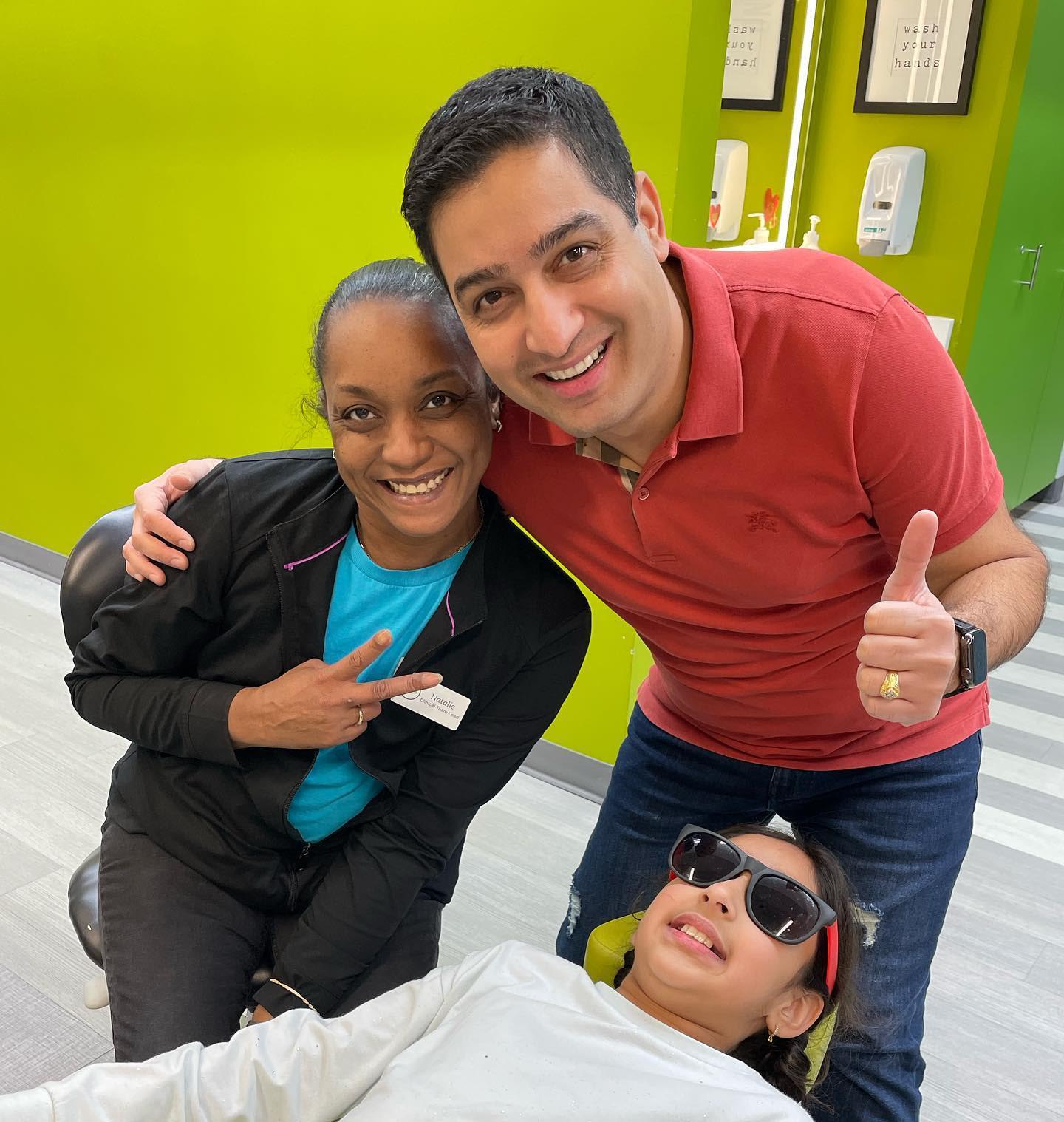 Doctor and assistant giving thumbs up to a patient at Behl Orthodontics
