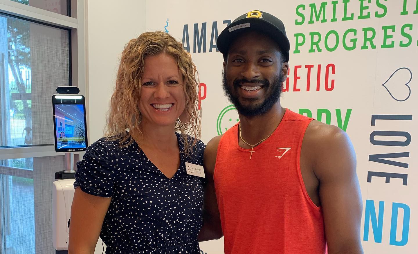 Confident adults smiling at Behl Orthodontics