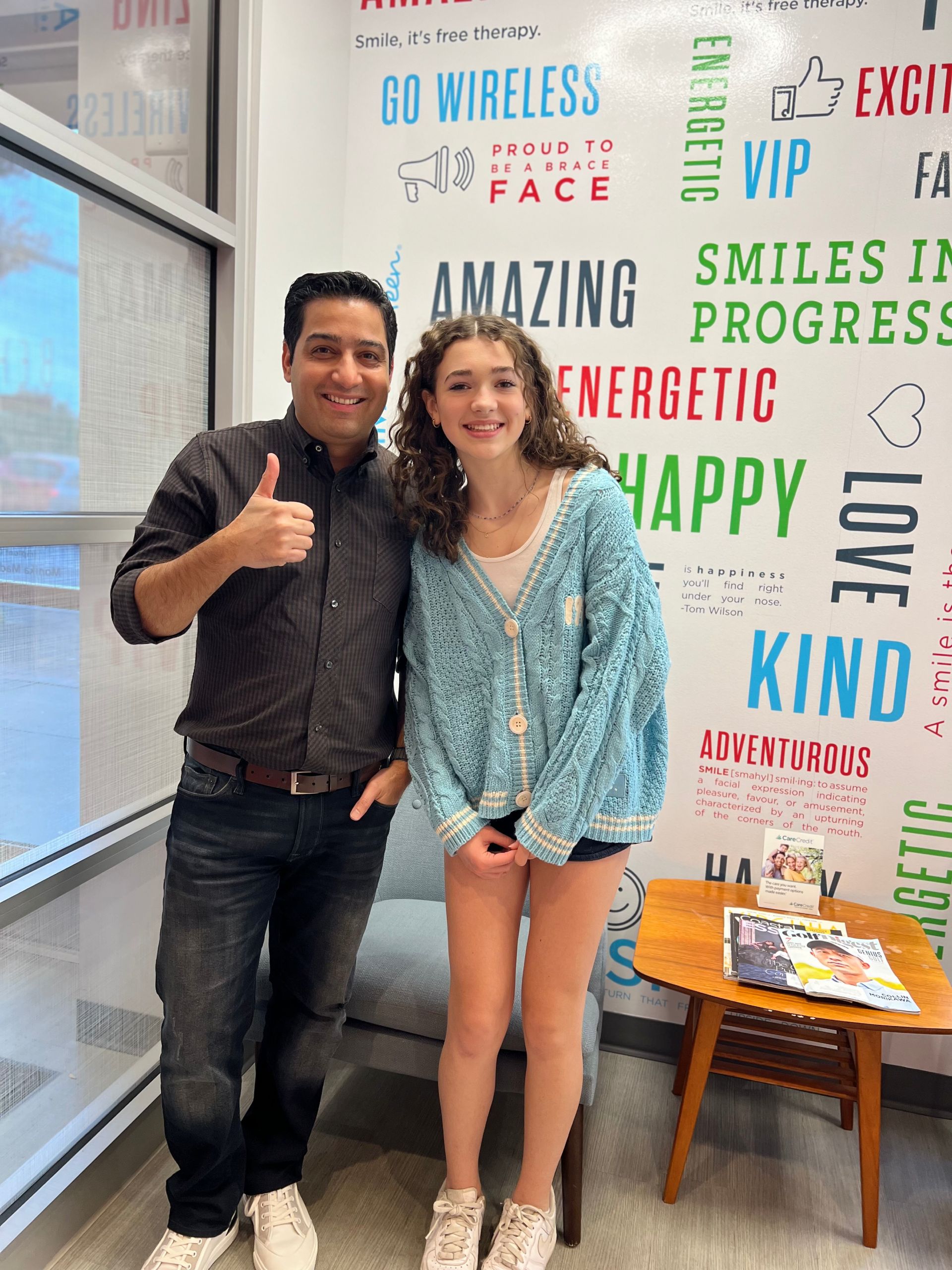 Orthodontist and happy teen patient giving thumbs up at Behl Orthodontics