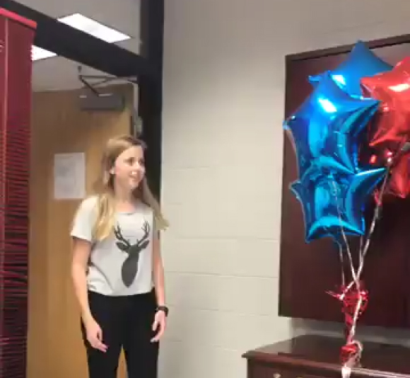 Surprised and happy young girl at school