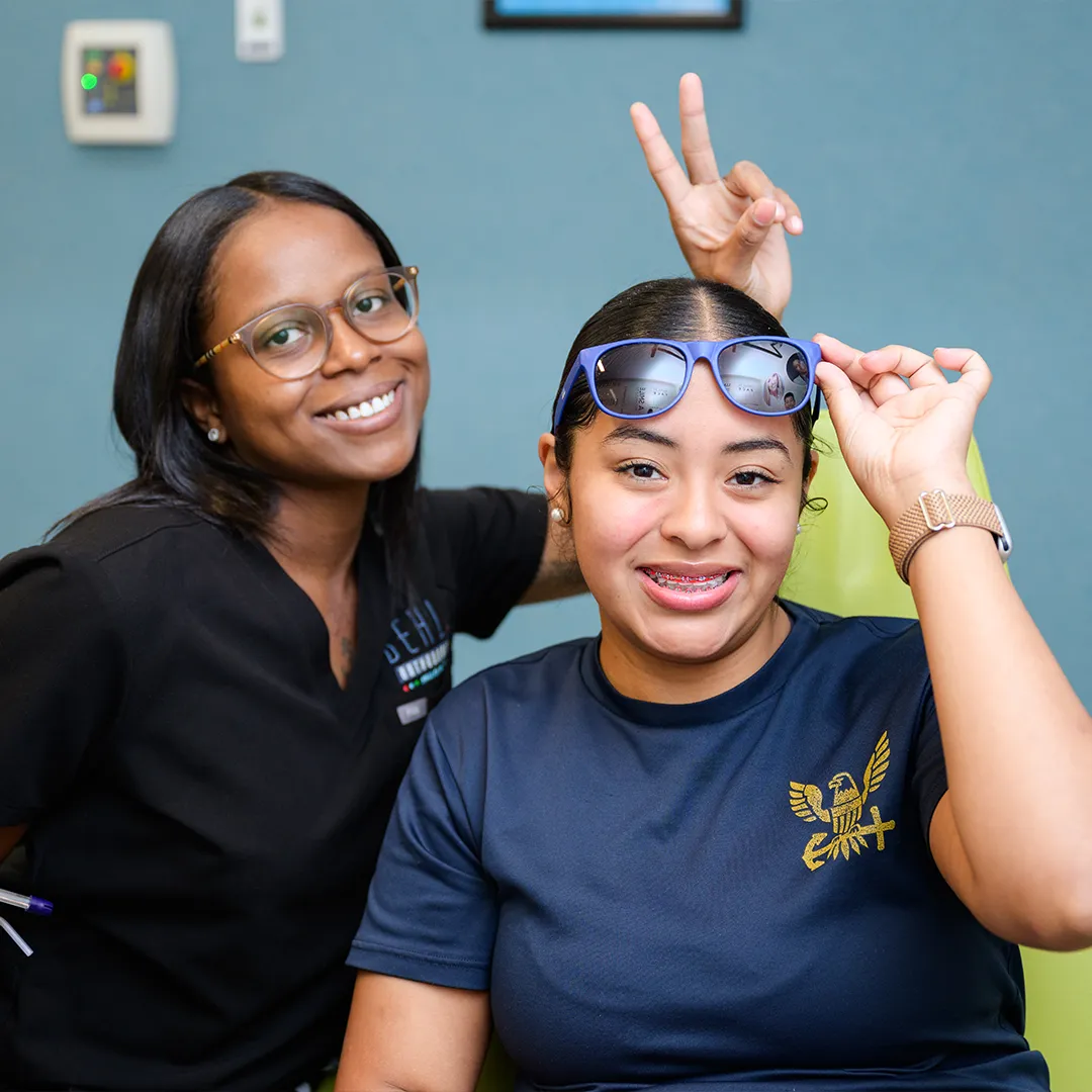 Young patient confidently showing off her braces at Behl Orthodontics