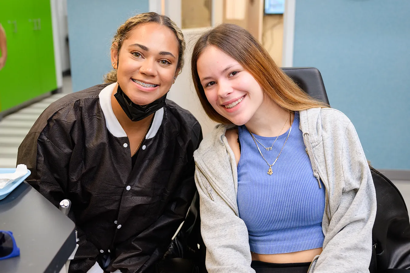 Two women smiling, one with new braces, at Behl Orthodontics