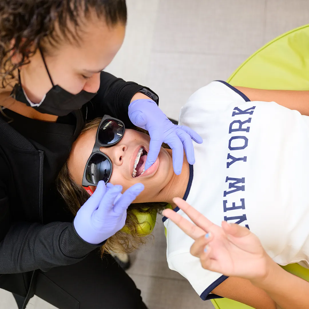 Stylish young patient smiling with her new braces at Behl Orthodontics