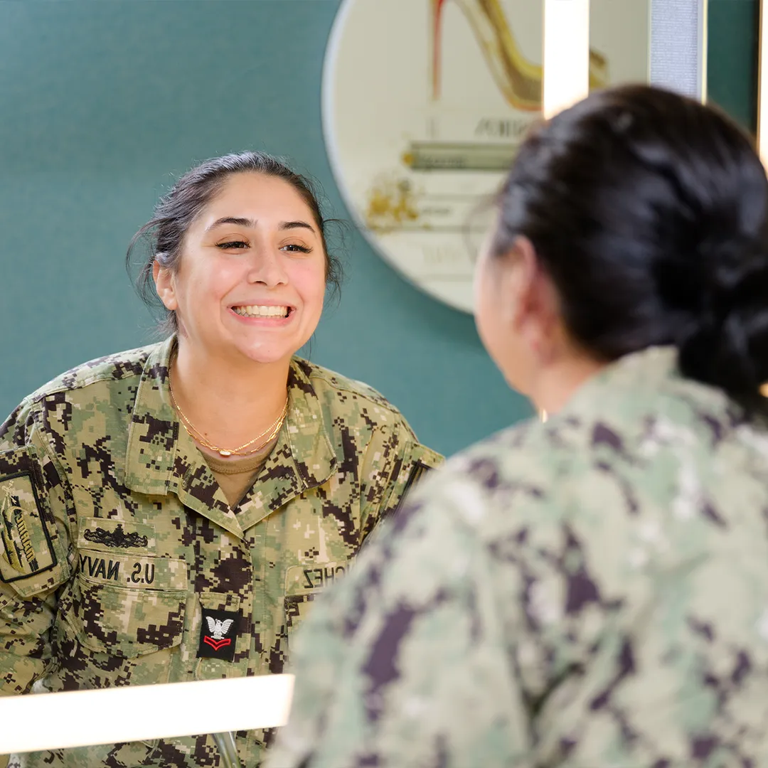Confident US Navy servicewoman smiling with her new braces